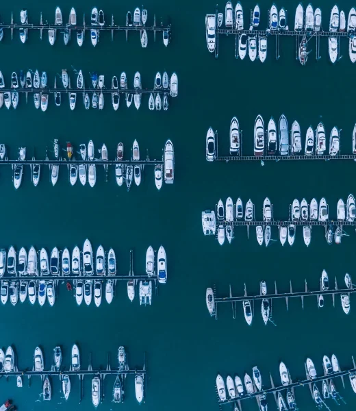 Image taken from above showing many boats in a harbour